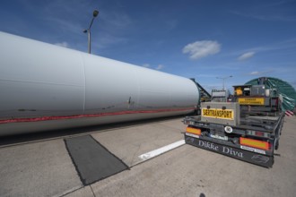 Overlong heavy-duty transporter with a part of a wind turbine, at a motorway rest area of the A9,