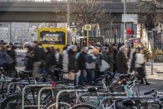 Passers-by on a Grunerstraße pedestrian crossing near Alexander Platz, bicycle parking lot in
