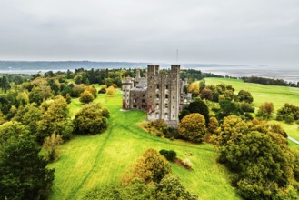 Autumn colours over Penrhyn Castle and Garden from a drone, Llandygai, Bangor, Gwynedd, North