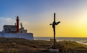 Religious scene, temporary Christian cross on the coast, Farol de Cabo Raso lighthouse, Sao Bras de