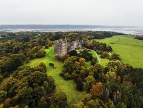 Autumn colours over Penrhyn Castle and Garden from a drone, Llandygai, Bangor, Gwynedd, North