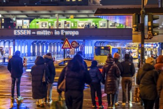 The main train station in Essen, blue illuminated underpass, bus station, am Europaplatz, train on