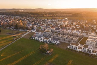 Residential area with fields photographed from the air at sunset, peaceful atmosphere,