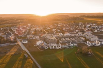 Extensive village with modern new buildings and fields at sunset, Althengstett, Calw district,