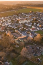 Aerial view of a village at dusk surrounded by fields and forests, Althengstett, Calw district,