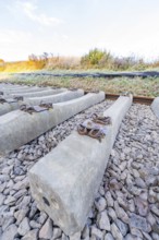 Close-up of concrete sleepers on gravel in an autumn landscape, track construction of the Hermann