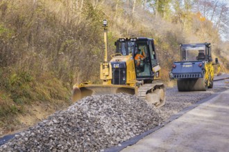 Bulldozer and road roller processing ballast on a construction site, Hermann Hesse Railway track
