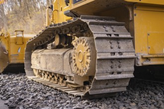 Close-up of a chain tractor on gravel, part of construction, track construction of the Hermann