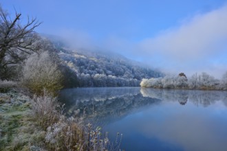 Winter river with frozen bank and fog over trees, clear atmosphere, hoarfrost, winter, Boxtal,