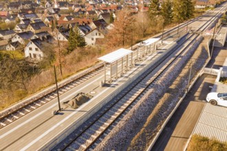 Station with two tracks in a small village surrounded by autumn trees, new Hermann Hessebahn