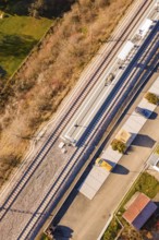 Railway line and platform in rural surroundings, with surrounding roads and vegetation, new Hermann
