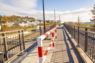 Footbridge with barrier in a modern environment, new Hermann Hessebahn railway station, Ostelsheim,