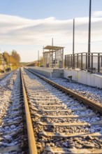 Abandoned train tracks at a small train station in autumn light, new Hermann Hessebahn station,