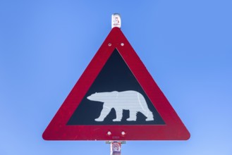 Polar bear warning sign against blue sky, Spitsbergen, Svalbard, Norway