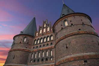 Holstentor, historic city gate from 1478, evening sky, Holstentorplatz, Hanseatic City of Lübeck,