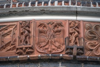 Terracotta figures at Holsten Gate, historic city gate from 1478, Holstentorplatz, Hanseatic City