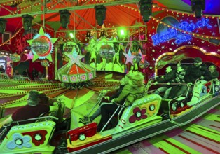 People on the Musik-Express ride at the All Saints Fair, the biggest old town fair in Europe,