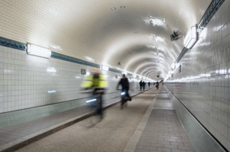 Interior view, pedestrians and cyclists crossing tunnel, mopping effect, movement, tube, historic