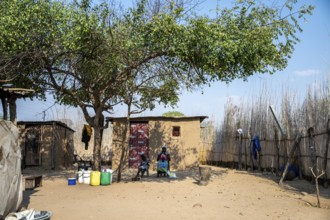 Locals in a typical village with clay huts, Caprivi Strip, Namibia