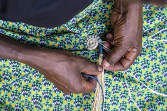 Local woman weaving baskets from papyrus, near Fort Portal, Uganda