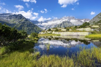 Picturesque mountain landscape, dammastock and damma glaciers reflected in Moorsee, Göscheneralp,
