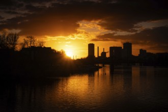 The sun sets behind the Main and Frankfurt Westhafen Tower, Alte Brücke, Frankfurt am Main, Hesse,