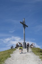 Summit cross with tourists, Brauneck 1555m, Bavarian Prealps, Isarwinkel, Lenggries, Upper Bavaria,