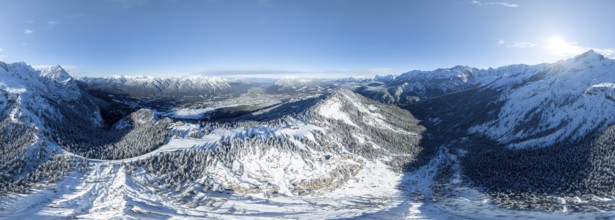 Wonderful winter landscape with Zugspitze, blue sky and snow, mountains and mountain valley, aerial