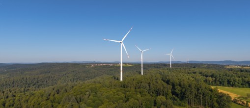 Wind turbines in a green hilly landscape, standing in a clear sky, near Schorndorf, Remstal,