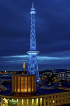 Blue-lit Berlin radio tower, steel half-timbered building by architect Heinrich Straumer, Langer