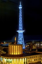 Blue-lit Berlin radio tower, steel half-timbered building by architect Heinrich Straumer, Langer
