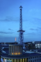 Blue-lit Berlin radio tower, steel half-timbered building by architect Heinrich Straumer, Langer