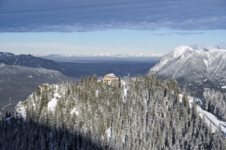 Snowy forest and Kreuzeckhaus mountain hut in the Garmisch Classic ski area in winter, Wetterstein