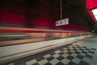 HafenCity University underground station, illuminated in color, red, underground train, movement