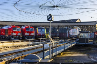 Turntable and overhead line spider, behind it modern locomotives of the Austrian Federal Railways,