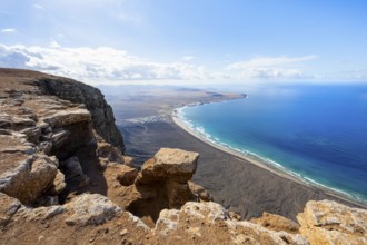 View from the Risco de Famara Cliff to Famara Beach, Playa de Famara with La Calaeta, Lanzarote,