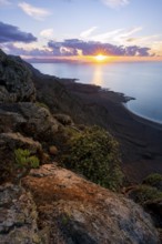 View from steep cliffs to sea and coast with sun stars, Mirador del Porrito viewpoint at sunset,