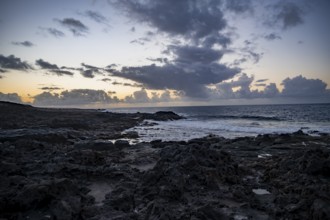 Seaside coast with volcanic rocks at sunset, La Santa, Lanzarote, Canary Islands, Spain