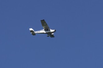 Cessna 172C Skyhawk aircraft flying in a blue sky, England, United Kingdom