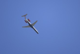 Embraer ERJ-145 jet passenger aircraft of Loganair airlines flying in a blue sky, England, United