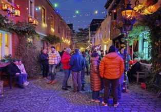 People in the Tiefstraße decorated for the Martin train in the evening, historic old town, Kempen,