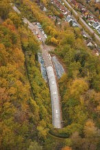 Autumn forest surrounds the construction site of a railway tunnel under construction,
