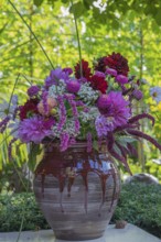 A colorful bouquet of flowers in a decorative vase in the garden, North Rhine-Westphalia, Germany