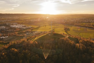 Extensive panorama with fields, forest and a wind turbine in the evening light, Grüner Heiner,