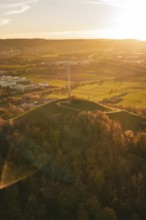 A hilly autumn landscape with wind turbine in warm sunset, Grüner Heiner, Korntal, Germany