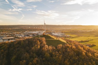 A panoramic view of an urban landscape with wind turbine on a hill, Grüner Heiner, Korntal, Germany