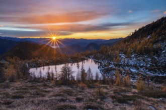 Laghetto dei Saléi mountain lake with autumnal larches (Larix) at sunrise, Onsernone Valley, Canton