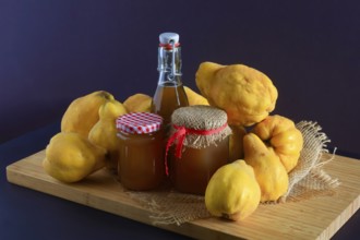 Still life with quinces, homemade quince jelly and quince liqueur, autumn, Germany