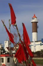 Timmendorf lighthouse on the island of Poel on the Baltic Sea, rigging and flags from a boat in the