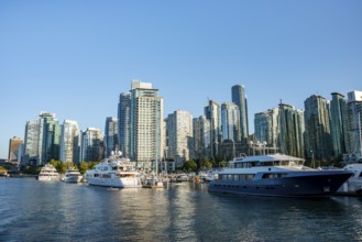 Sailing boats in marina, skyscrapers on the promenade, Coal Harbour, Vancouver, British Columbia,